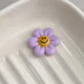 Close up of purple resin flower cabochon with cute smile face, ideal for DIY jewelry making. - Lilac Purple