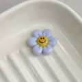 Resin purple smiley flower charm close-up, perfect DIY accessory for bracelets and crafts. - Ireland