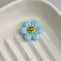 Blue resin smiley flower cabochon detail shot for DIY jewelry making and cute craft accessories. - Ice Blue