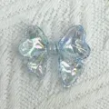 Transparent iridescent bow acrylic DIY jewelry accessory close up showing colorful light details. - Transparent Blue