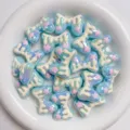 Acrylic macaron bow beads with dripping cream and pink stars, perfect for DIY phone charms and crafts. - Blue And White