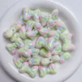 Close-up of iridescent pastel bow acrylic beads, perfect for DIY jewelry and phone charms. - Yellow and Green