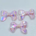 Detaillierte Nahaufnahme schimmernder irisierender pinker Acryl-Schleifenperlen zum Basteln. - 24*32mm / Rosa