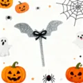 Detail view of the silver glitter bat cake topper with a black bow for Halloween party decor. - Silver Glitter Bat with Black Bow