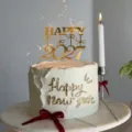 Gold 2027 acrylic cake topper detail view, perfect for New Year party decoration and celebration. - Happy 2027 Self-Adhesive Gold & Transparent