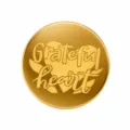 Gold acrylic cake topper detail showing Grateful heart engraved design for Thanksgiving decor. - Grateful Heart / Gold