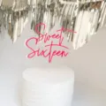 Close up view of pink sweet sixteen acrylic cake topper detail on white birthday party cake. - Sweet 16 / 1.3mm Thick (Width 10cm) / Transparent & Rose Red