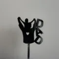 Close-up detail of the black acrylic father's day cake topper with silhouette design. - DAD Silhouette Carrying Child / Width Approx 8CM / Black