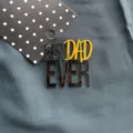 Detail shot of the acrylic Best Dad Ever cake topper on textured dark background for party. - Black & Gold - Best Dad (Side Ornament) / Width Approx 7CM