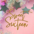 Close-up view of gold glitter Sweet Sixteen acrylic cake topper for sweet birthday party decor. - Sweet 16 / 2.5mm Thickness (Width 10cm) / Transparent + Glitter Gold