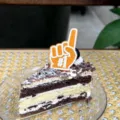 Detailed close-up view of an orange number one shape cake topper insert shown on a dessert. - Finger #1 Dad / Height approx 6cm / Orange