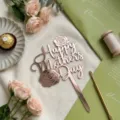Rose gold acrylic Mother's Day cake topper detail, elegant floral design with sweet props. - Rose Gold Marked Rose Happy Mother's Day