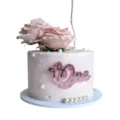 Pink acrylic One cake topper with artificial roses and pearls for first birthday party decor detail - Rose Gold And Glitter Pink One With Bow