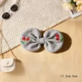 Grey fabric bow hair clip with red cherry embroidery, cute hair accessory measuring 11.5x6.5cm - Cherry / Blue