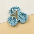 Blue woven straw flower detail shot, handmade floral DIY accessory with pearl beads center view. - Blue