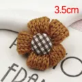 Handmade knitted wool flower hairpin accessory, brown floral decor with checkered button. - Turmeric