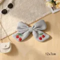 Grey fabric bow hair clip with cute red cherry embroidery, stylish accessory for daily wear. - Cherry Ribbon Knot / Blue