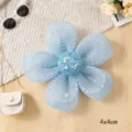 Close-up detail of light blue organza five-petal flower accessory with glitter center. - Blue Mesh Five-Petal Flowers