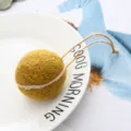 Wool felt ball pendant detail, handmade hanging ornament with rope, rustic style decor. - Turmeric
