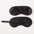 Black satin sleep mask for women and men, soft smooth blindfold for comfortable nighttime travel. - Black