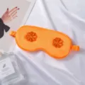 Orange silk sleep eye mask with 3D flower embroidery, breathable, comfortable for travel and home use. - Orange