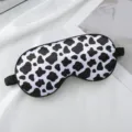 Black and white cow print sleep eye mask, soft satin blindfold for comfortable resting. - Cow Print