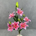 Close-up detail of 6-head artificial pink lily flower arrangement with green leaves in vase. - No. 1