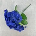 Close-up detail of artificial blue hydrangea flower, showing realistic petals and leaves. - Sapphire Blue