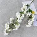 Artificial white pearl flower branch detail, realistic fake floral for home decor photography. - White