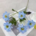 Close-up of blue artificial delphinium flowers on table decor, realistic fabric flower details. - Light Blue