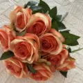 Artificial peach rose bouquet detail closeup, fabric material with green leaves for home decor. - Caramel Orange