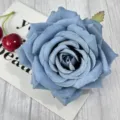 Detailed view of a blue artificial rose flower head with lush petals for DIY crafts and decor. - Fog Blue