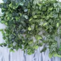 Detailed view of artificial hanging vine with white spotted leaves, ideal for wedding decor. - Cold Water