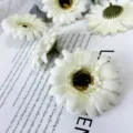 Close-up detail of white artificial daisy flower heads, perfect for table decor and props. - White