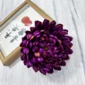 Detailed close-up of a dark purple artificial chrysanthemum flower head for decor. - Deep purple
