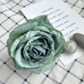 Green vintage artificial rose flower head for wedding decoration and floral wall backdrop design. - Cyan