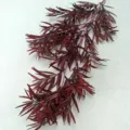 Detailed close-up shot of dark red artificial plastic pine bamboo leaf branch for wedding decor. - Dark Red