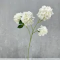 Close-up detail of white artificial hydrangea flower bunch for home decor and floral art. - White