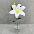 Close-up detail view of artificial white lily flower with green leaves for home decor. - White