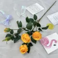 Artificial yellow rose branch with 5 flower heads and green leaves for home and wedding decor. - Yellow
