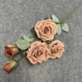 Detailed view of 5-head artificial rose branch, vintage brown tone for home decor. - Coffee