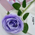 Single artificial purple rose flower stem with green leaves for wedding decor and party use. - Light Purple