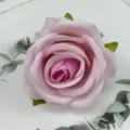 Close-up detail of artificial pink velvet rose flower head for wedding decoration and crafts. - Pink