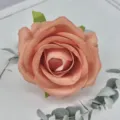 Close-up detail of artificial peach rose flower head, soft fabric floral decor for crafts. - Salmon Orange