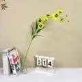 Artificial yellow orchid flower branch with glass vase, elegant home decor table arrangement. - Black Heart Green