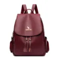 Women leather backpack vintage burgundy school rucksack with stylish tassels and flap closure. - Burgundy