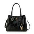 Black embossed letter handbag with top handles, crossbody strap and metal pendant. - Black