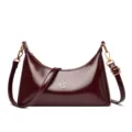 Dark red patent leather crescent shoulder bag for women, chic hobo bag with gold hardware. - Brown