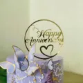 Detailed view of gold acrylic Happy Anniversary cake topper with decorative butterflies. - Style E With Stick
