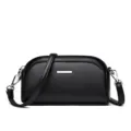 Black leather-textured small crossbody shoulder bag with silver metal bar and strap. - Black